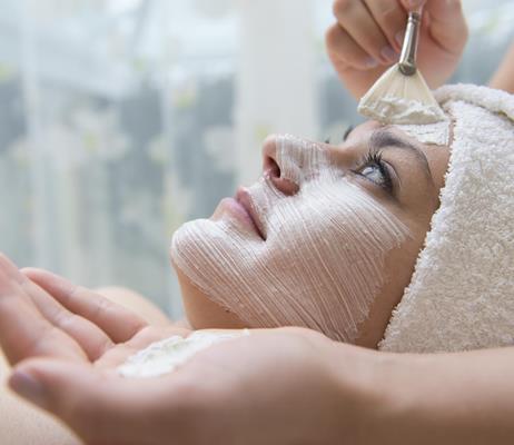 A woman is getting a facial treatment